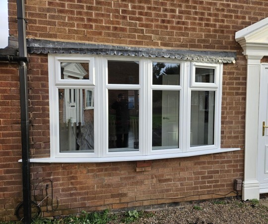 How secure are uPVC windows? White uPVC windows with multiple glazed panels installed in a residential brick home. 