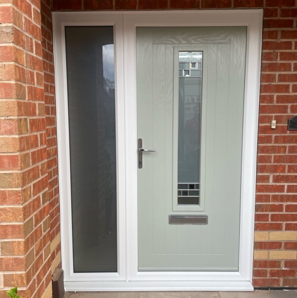 Composite doors and uPVC doors compared in a modern home entrance, showing a white front door with a glazed side panel.